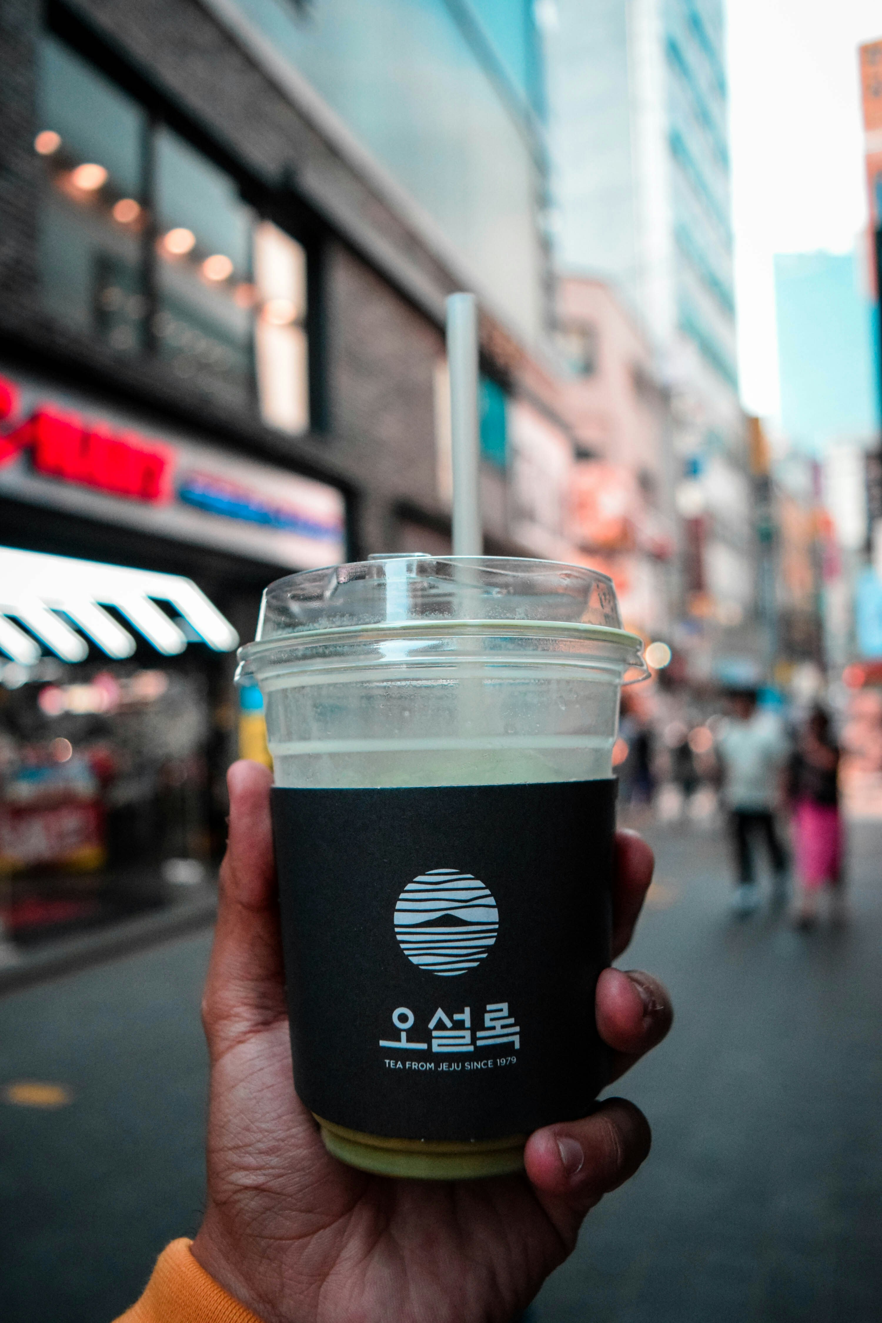 person holding black and white disposable cup
