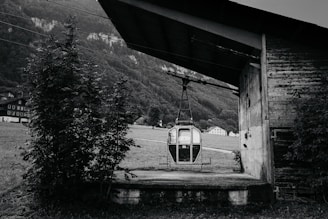Historic cable car station with vintage machinery and mountain backdrop.