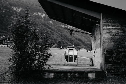 Historic cable car station with vintage machinery and mountain backdrop.