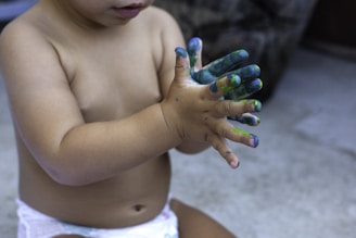 topless child with green manicure
