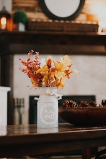 yellow and red flowers in white ceramic vase