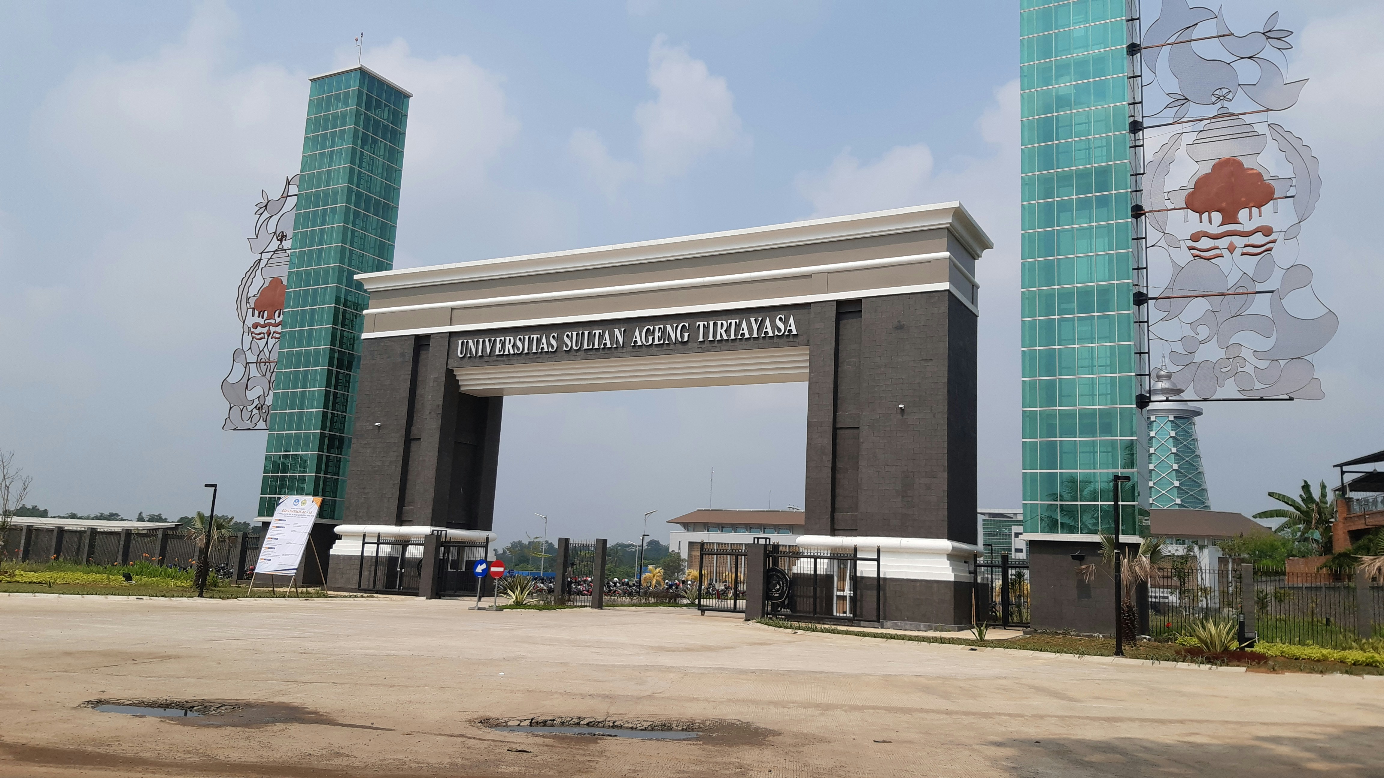 University campus entrance with modern security cameras and biometric access panels in bright daylight
