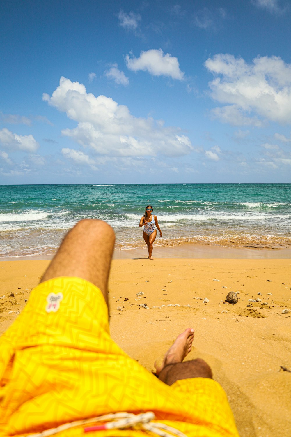 woman in black bikini walking on beach during daytime