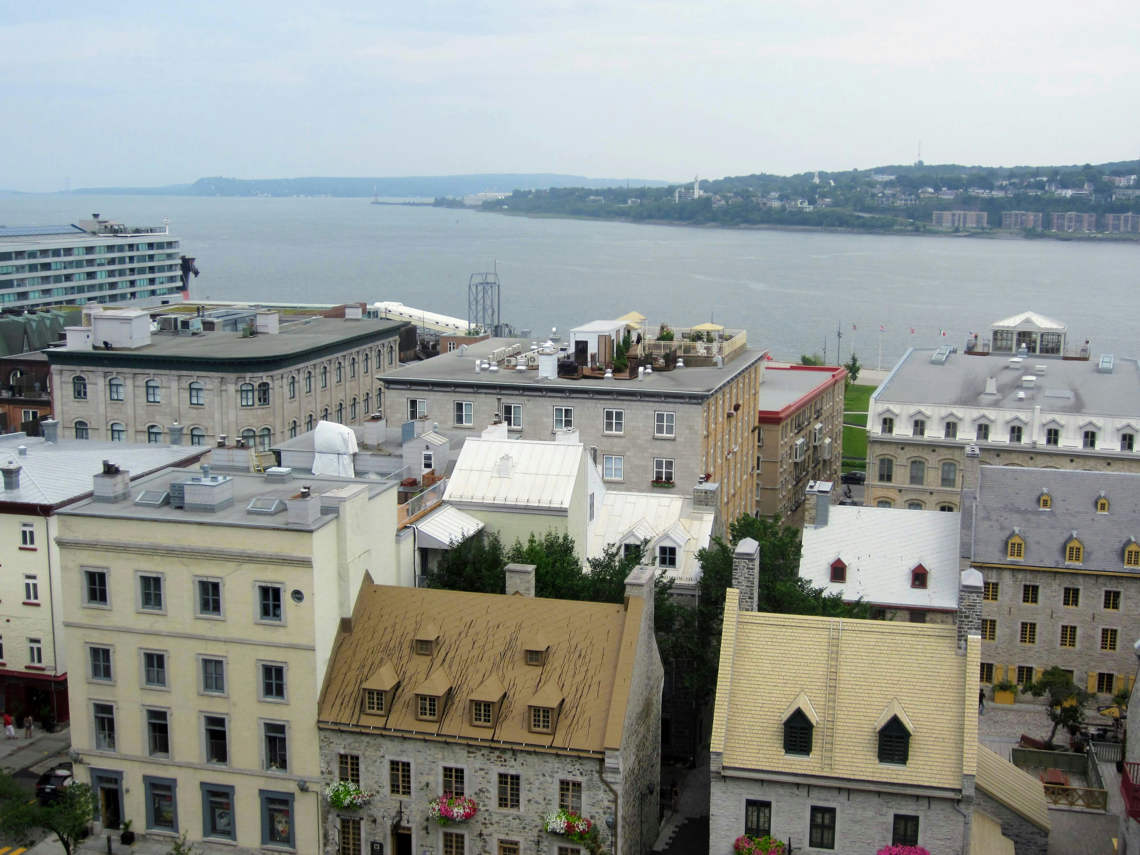 white and brown concrete buildings near body of water during daytime, 
