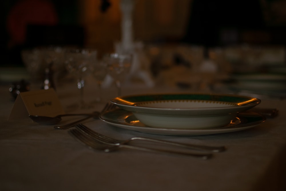 silver fork and bread knife on white ceramic plate