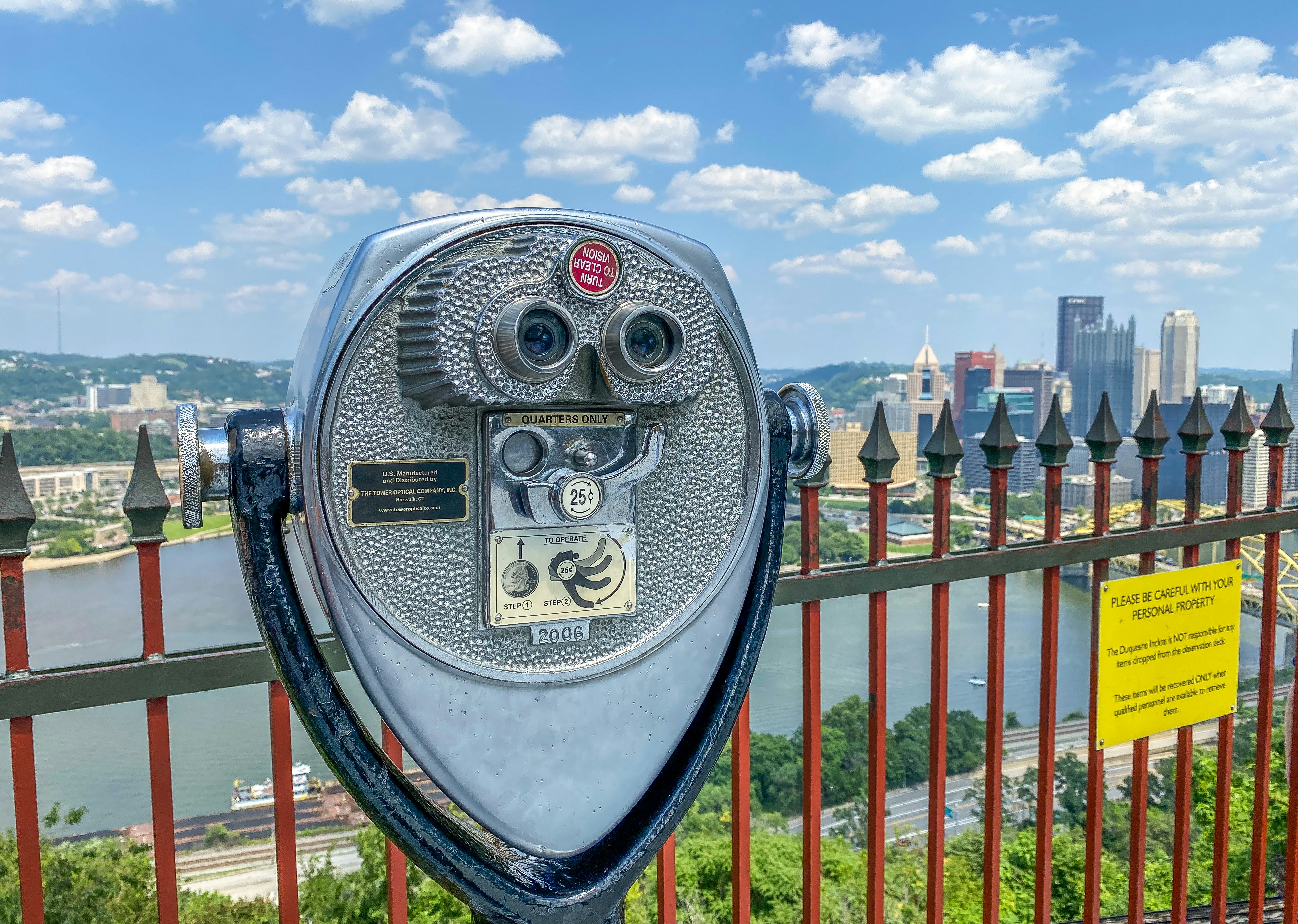 gray and black coin operated telescope under blue and white cloudy sky during daytime