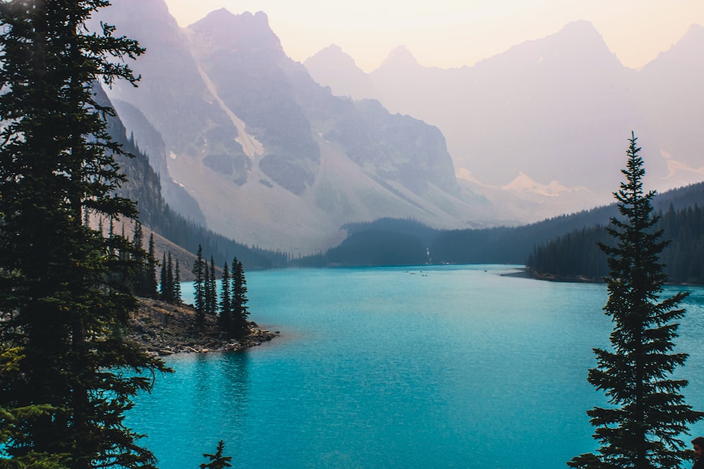 body of water near mountain during daytime