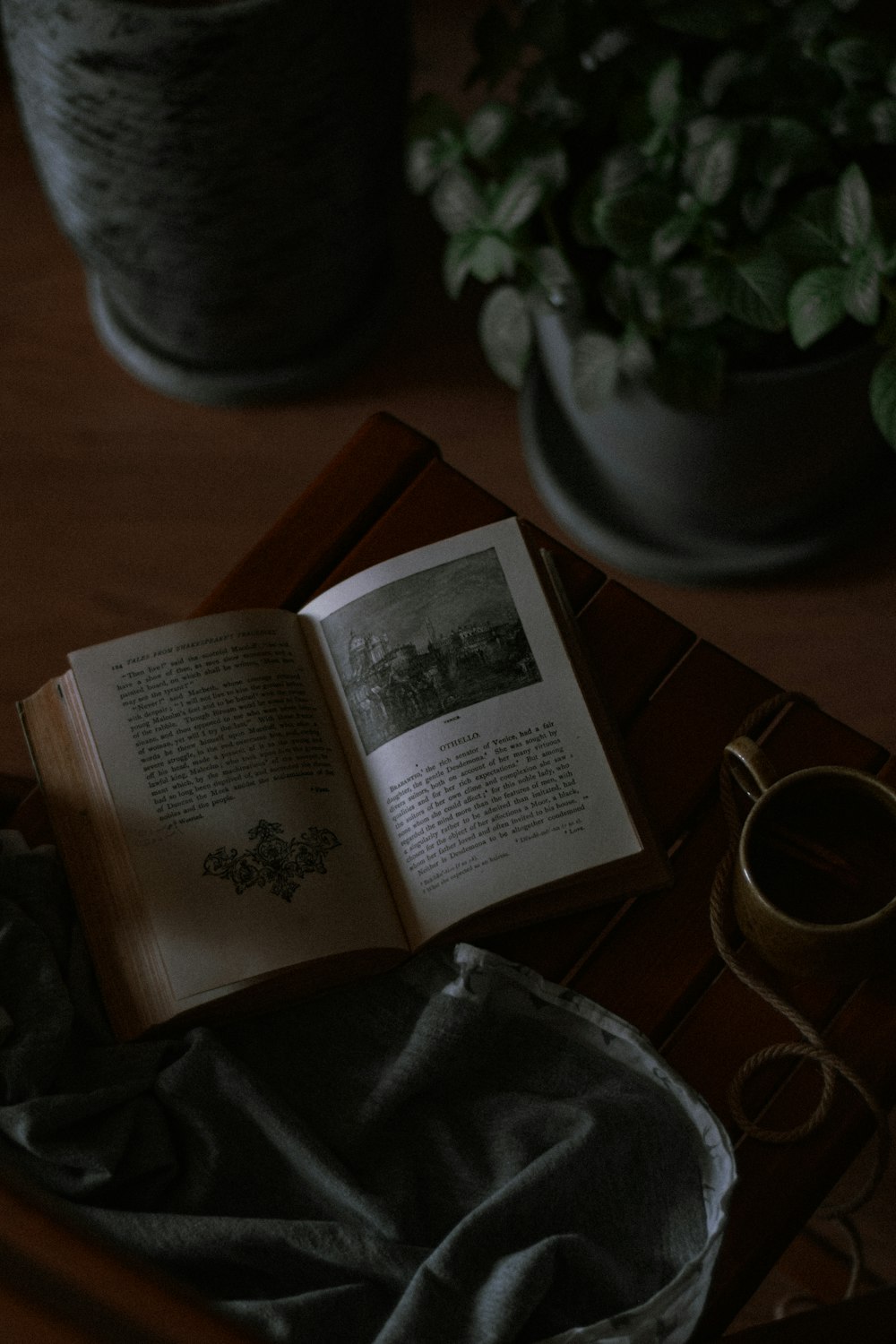 opened book on brown wooden table