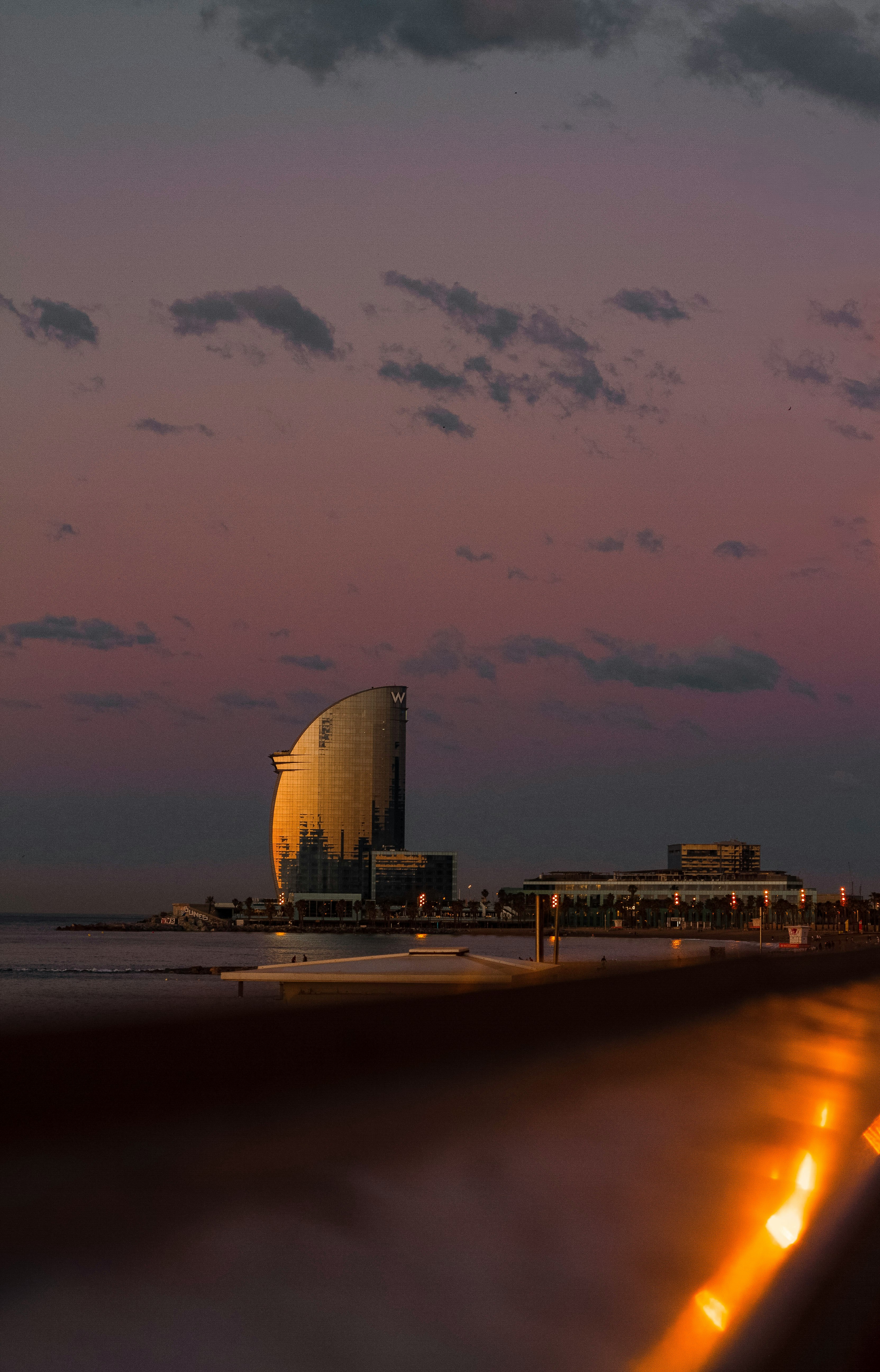 city skyline across the sea during night time