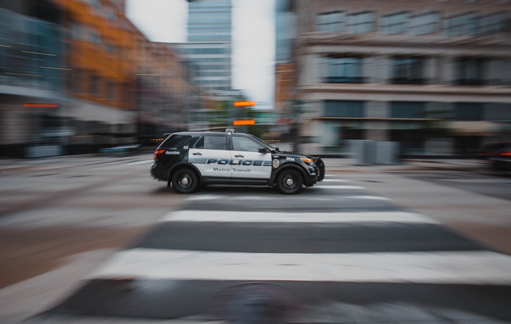 black and white police car on road during daytime