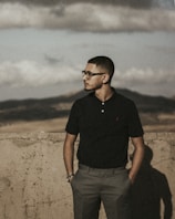 a man standing in front of a concrete wall