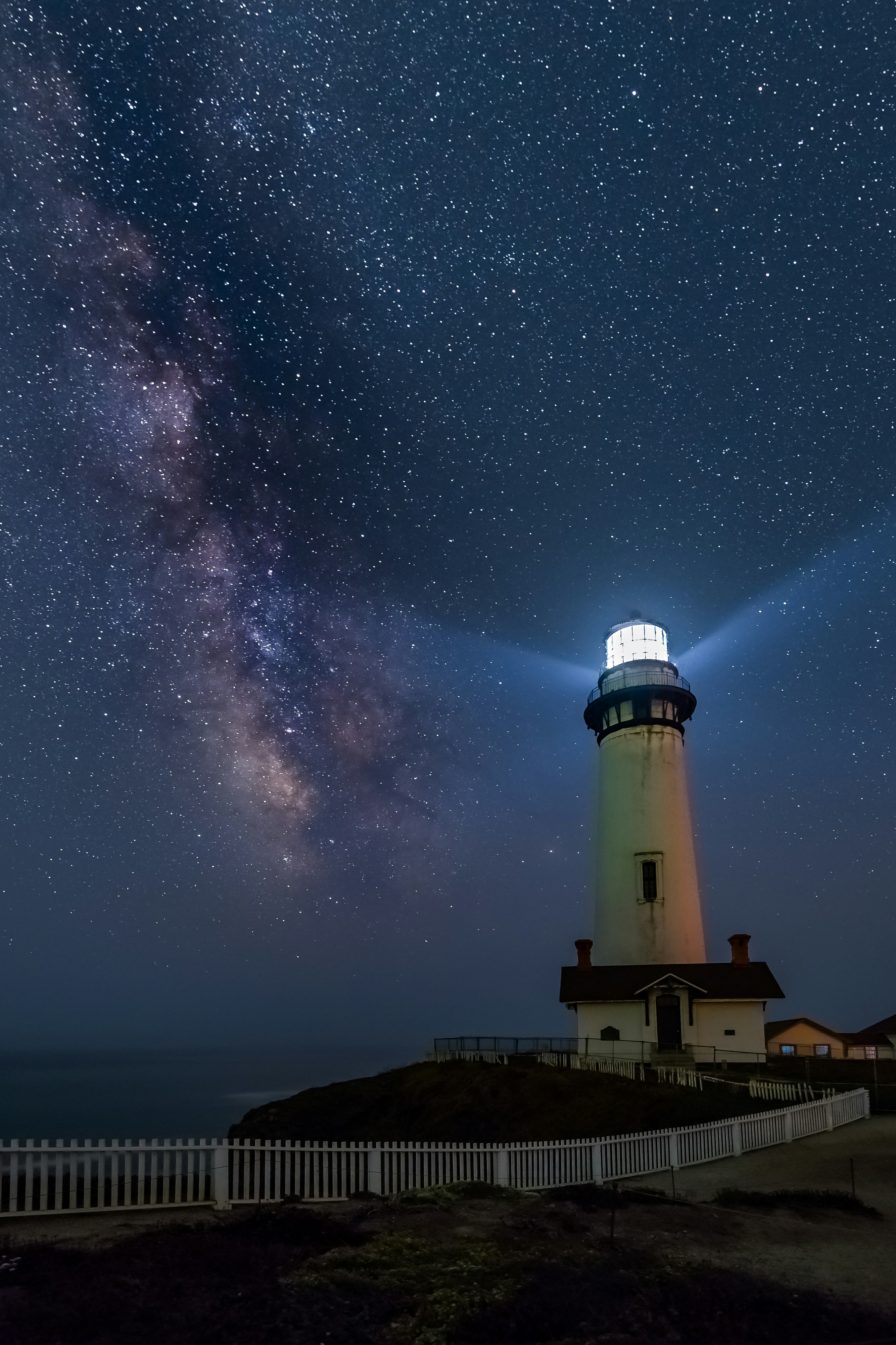 white and black light house under starry night