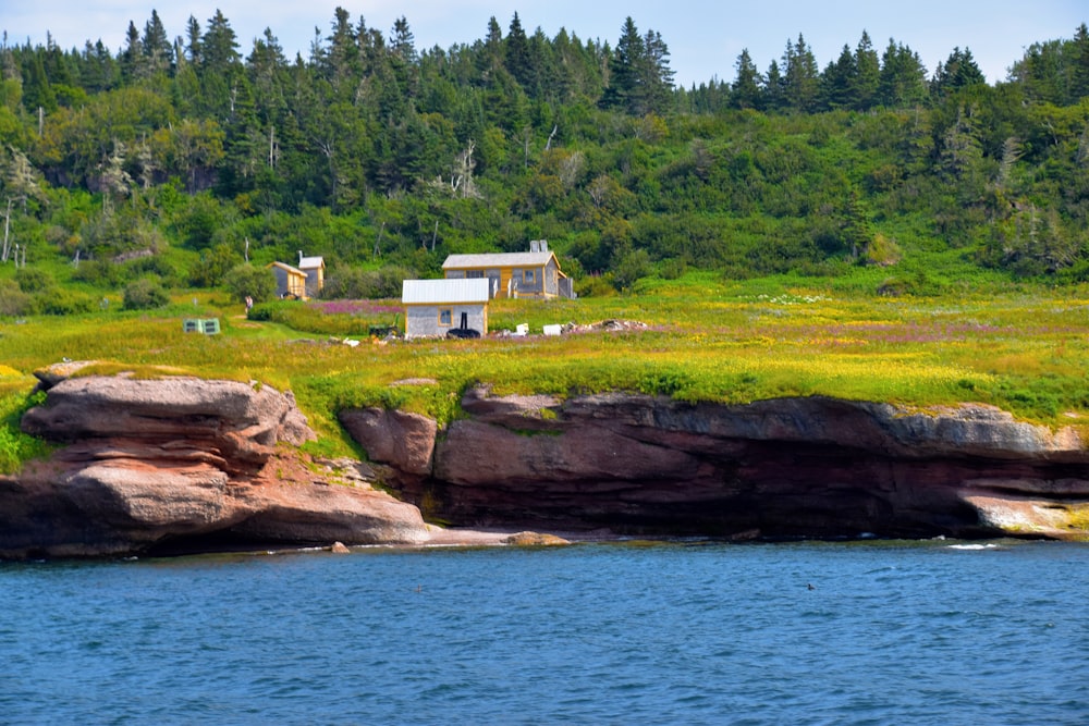 white and brown house near body of water during daytime