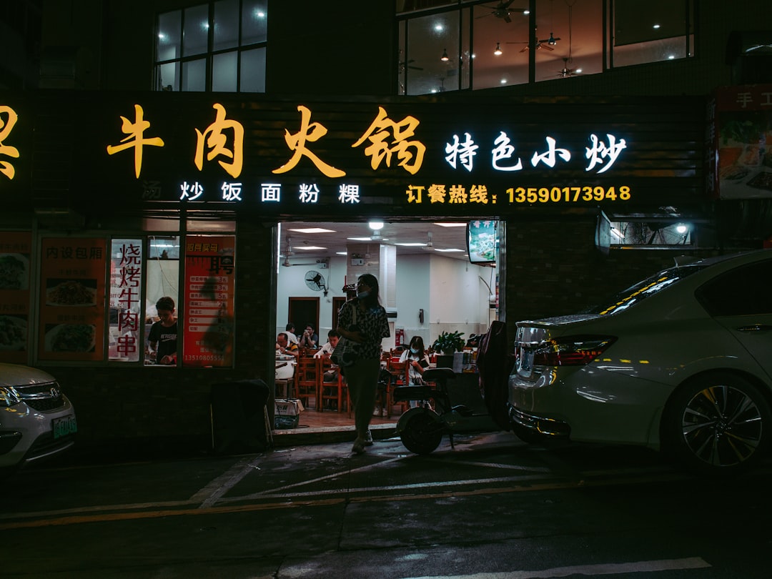 woman in red dress standing near store