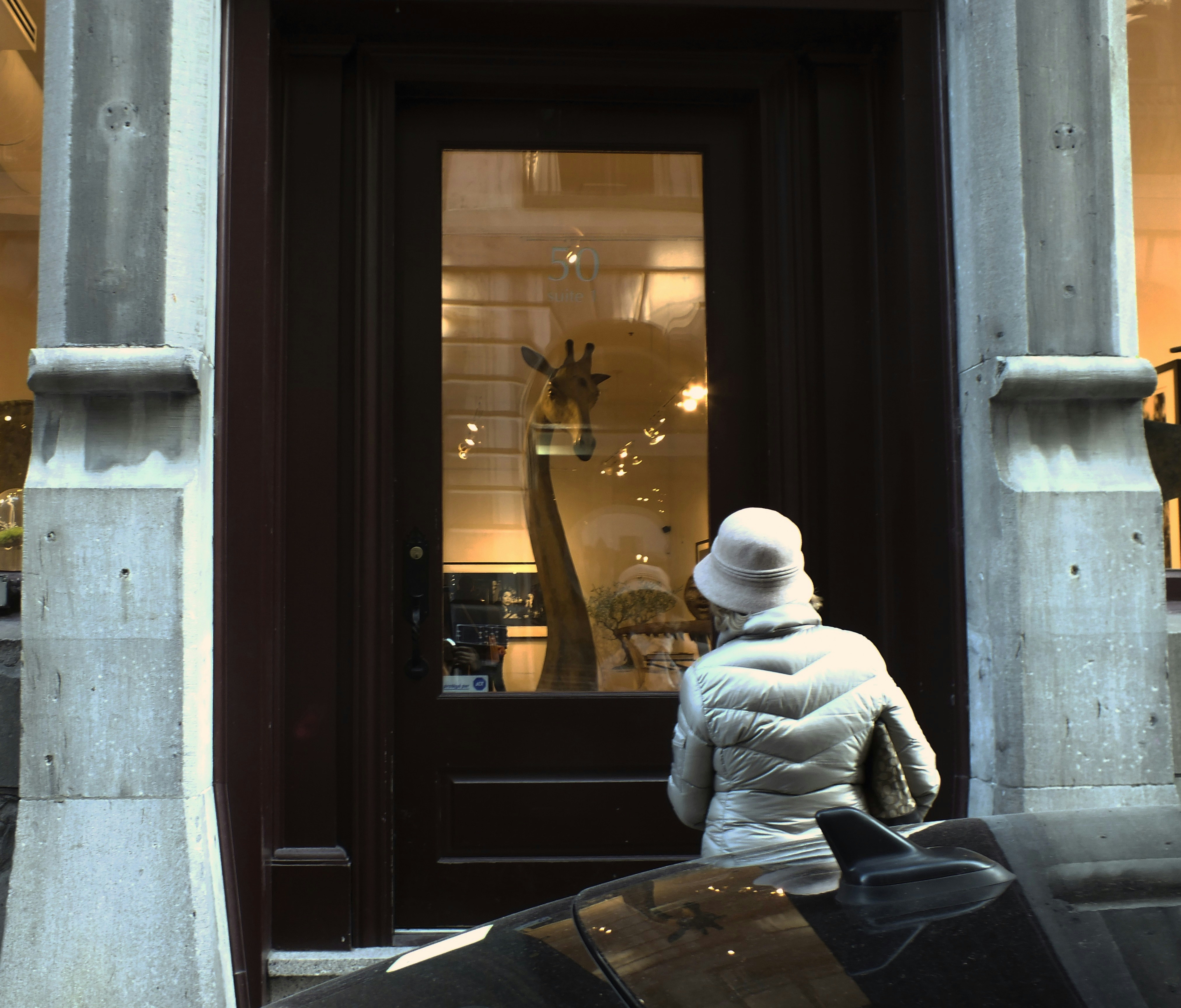 man in white jacket sitting on window during daytime
