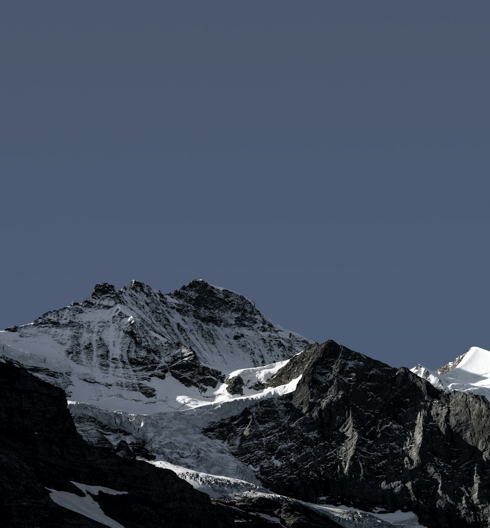 snow covered mountain under blue sky during daytime