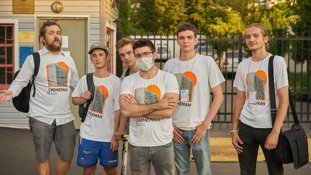 man in white crew neck t-shirt standing beside man in white crew neck t-shirt