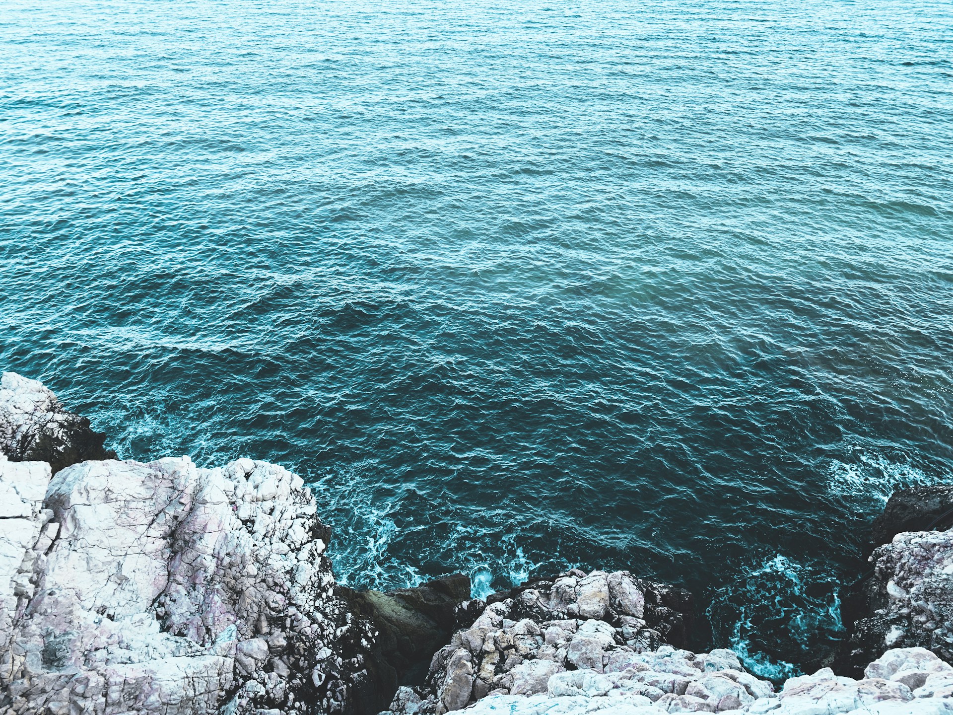 gray rocky shore with blue water