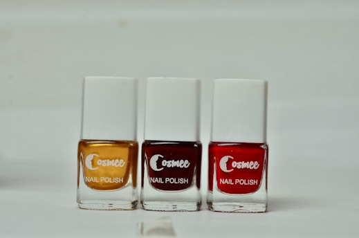 3 coca cola bottles on white shelf