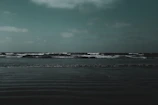 A quiet beach scene with subtle shadows and a minimalist color palette.