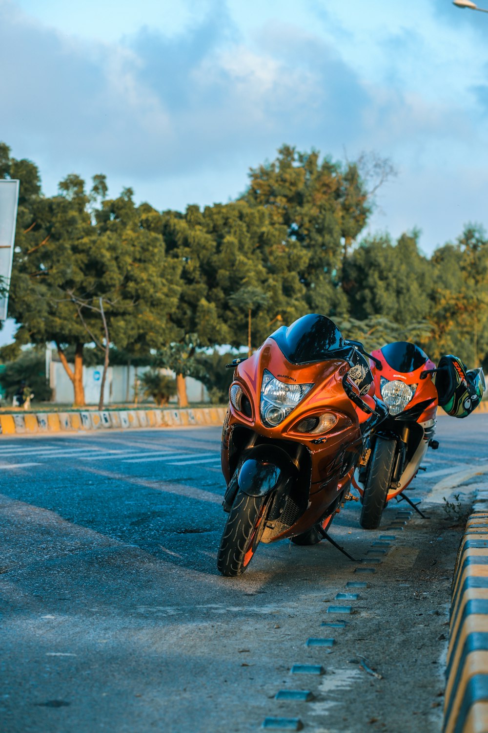 orange and black sports bike on road during daytime