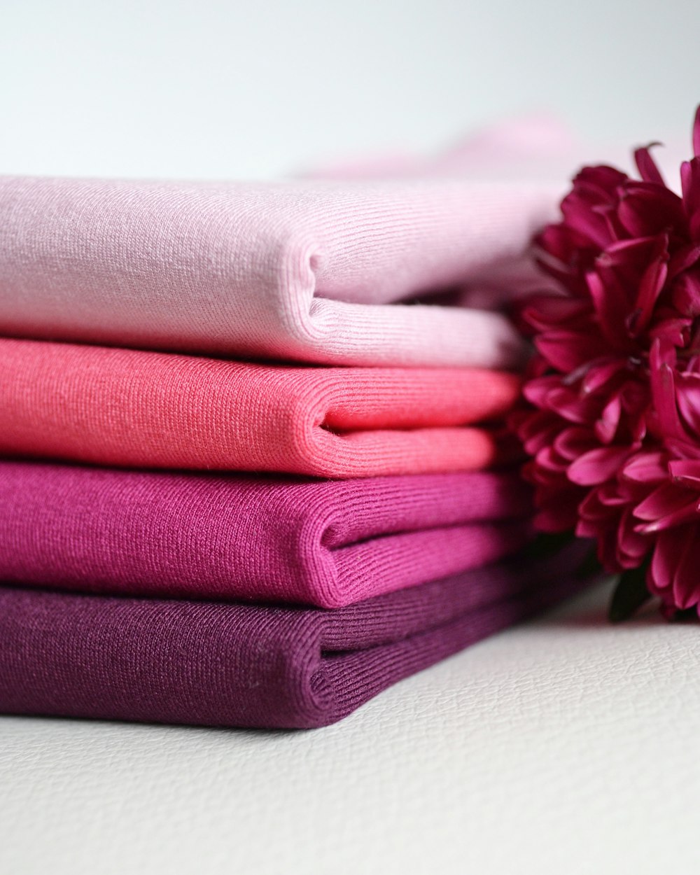 red and white flower on green towel