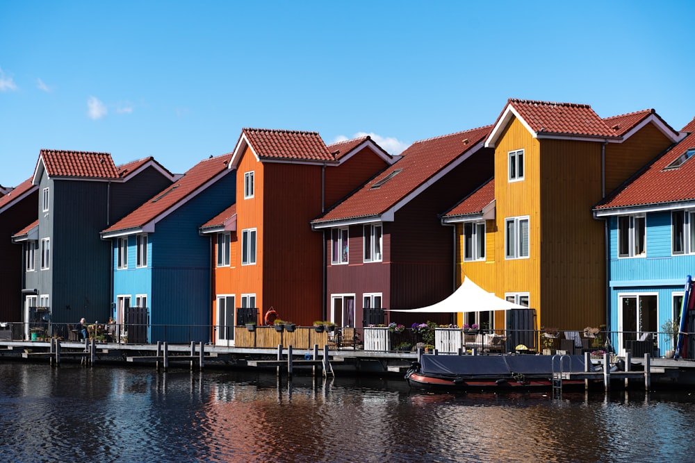 boat on dock near houses during daytime