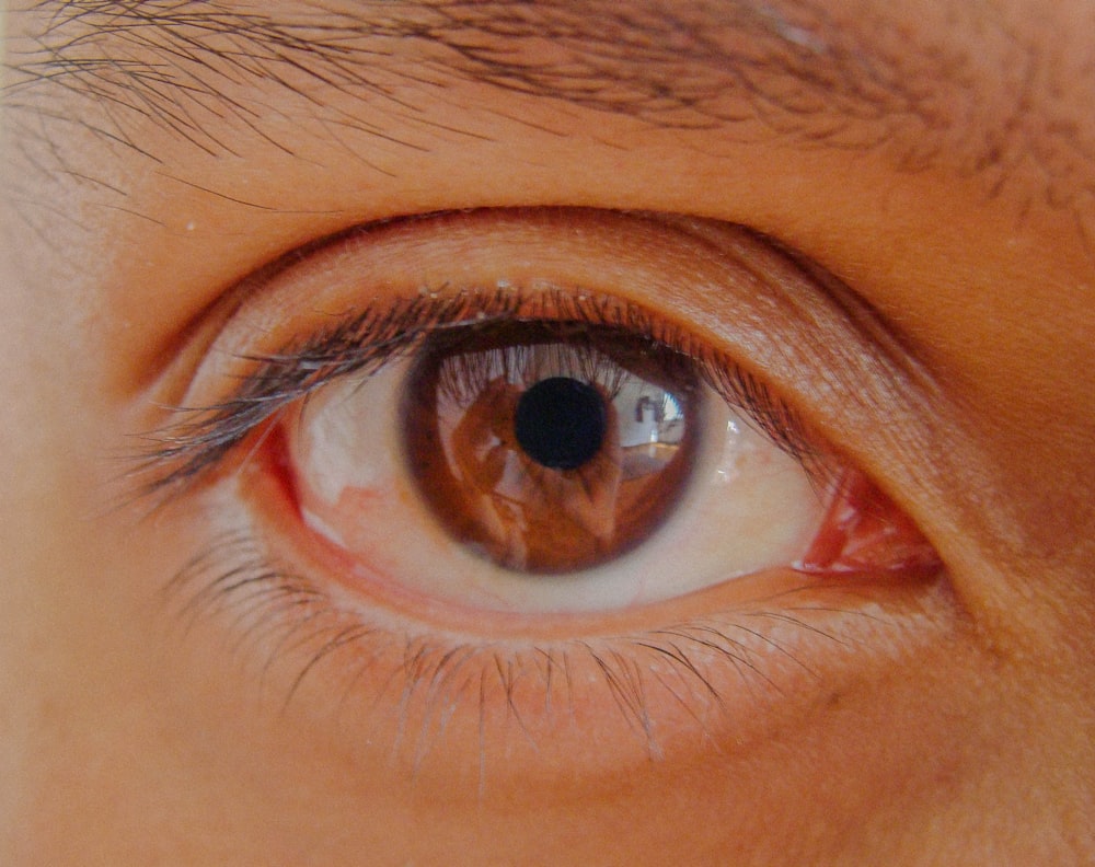 persons eye in close up photography