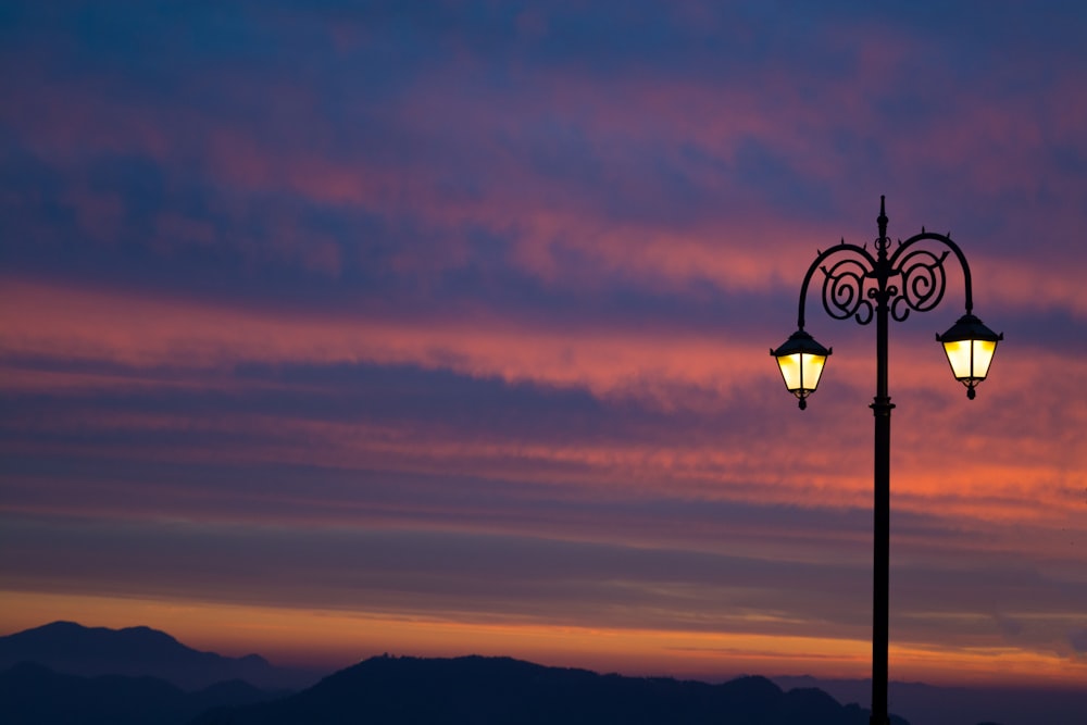 black street light during sunset