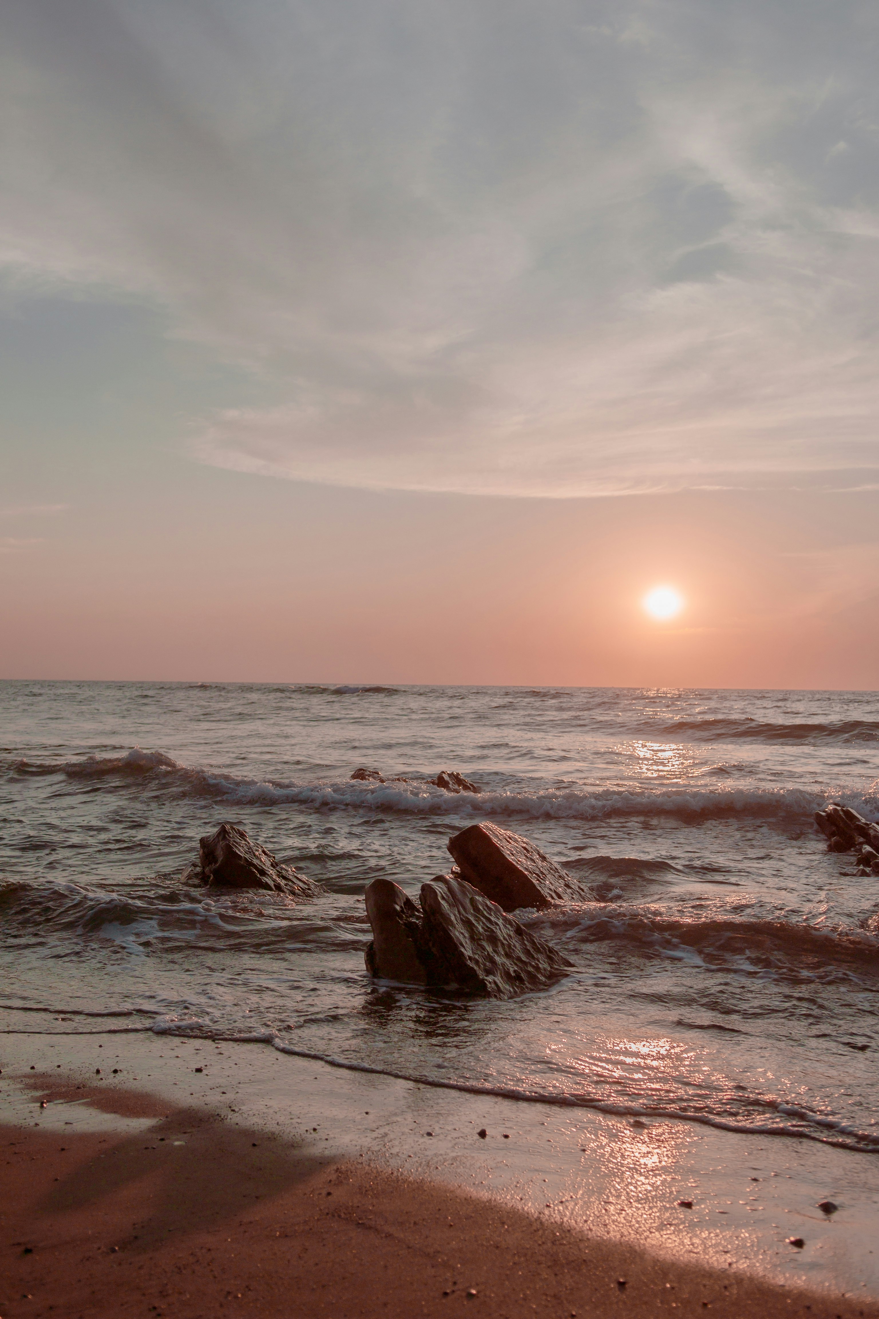 brown rock formation on sea during daytime