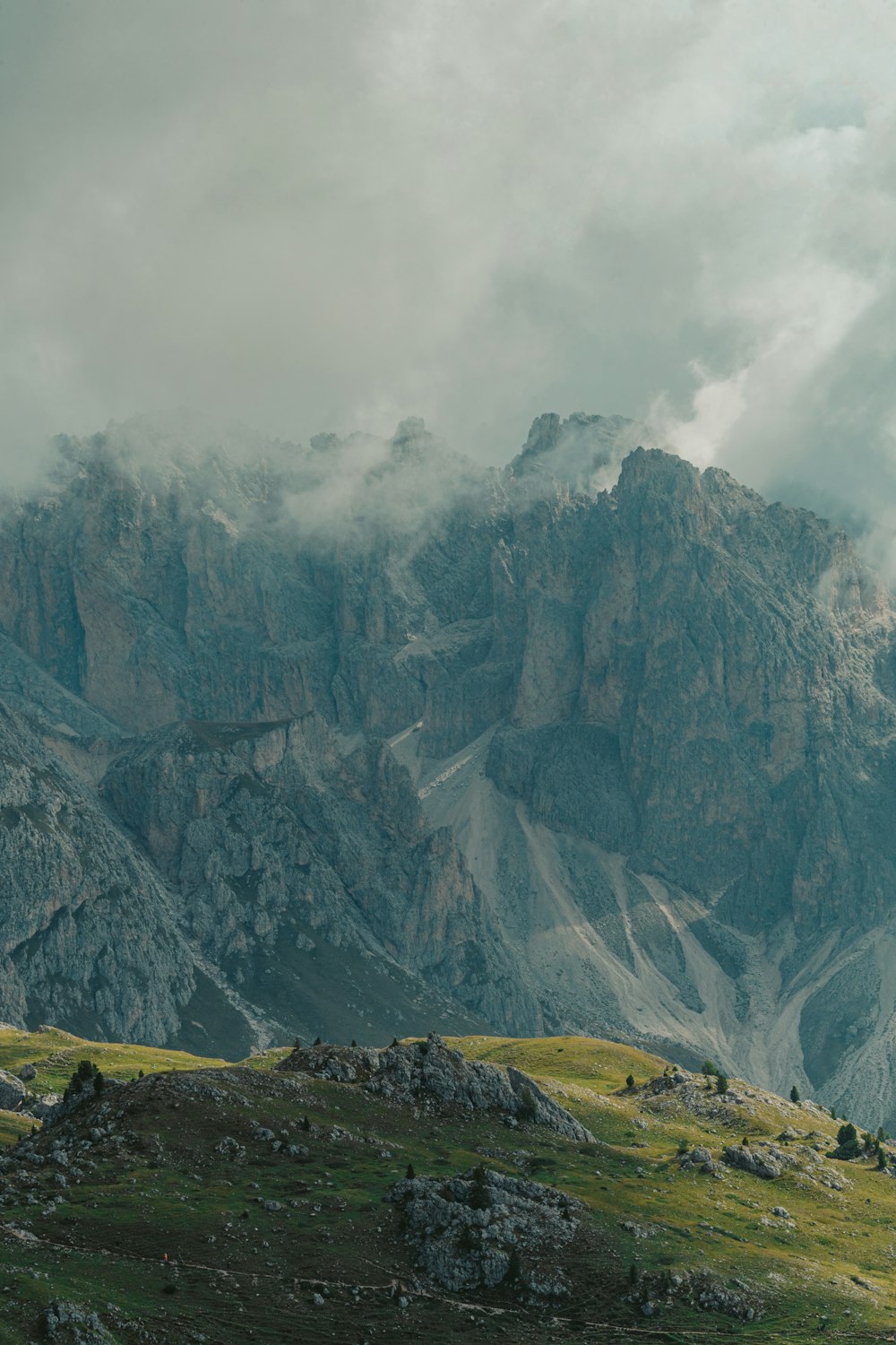 gray and green rocky mountain under white clouds during daytime