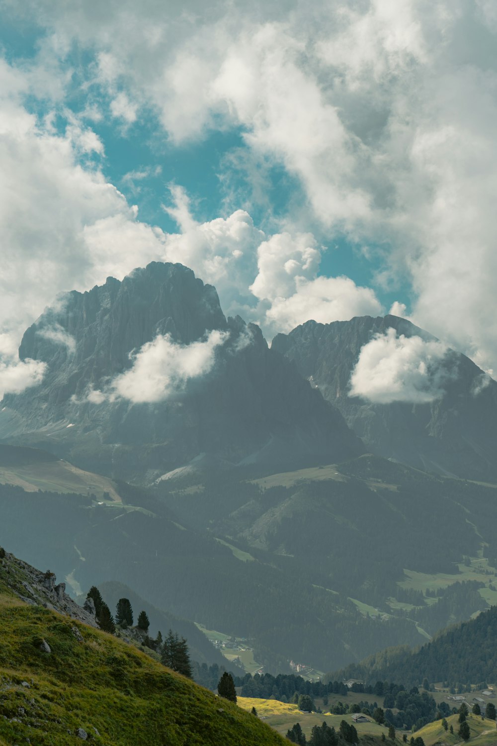 white clouds over mountains during daytime