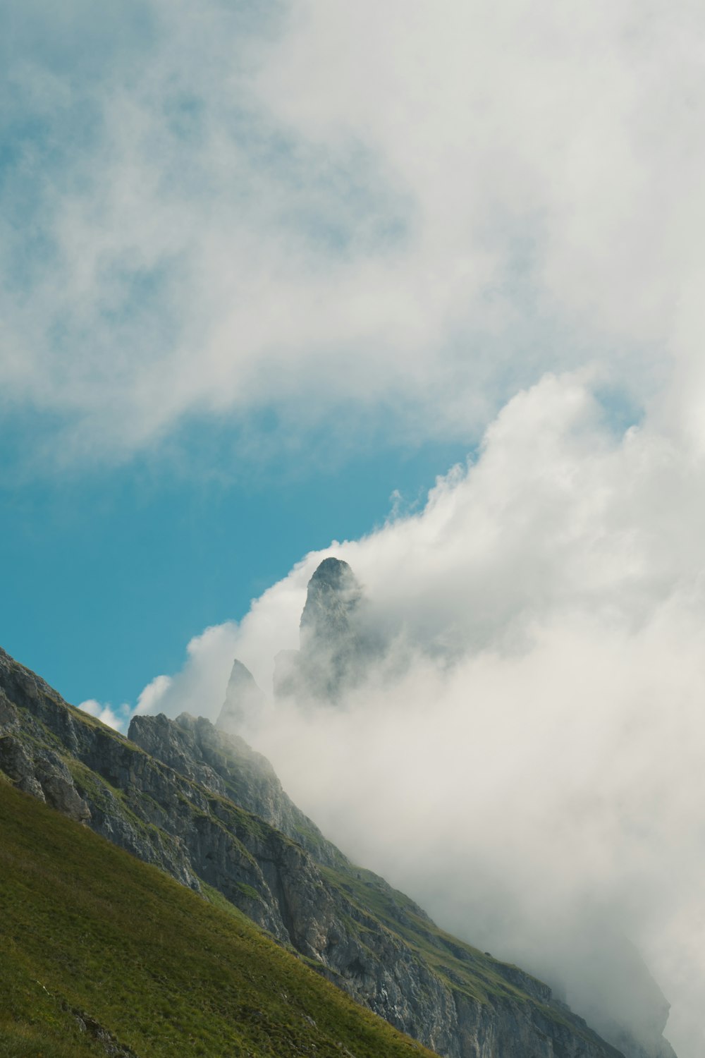 green mountain under white clouds during daytime