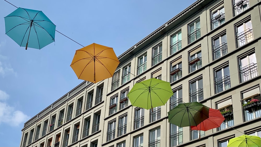 red umbrella near white concrete building