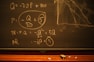 A blackboard with mathematical equations written in chalk, including variables like Q and P, and calculations involving these variables. An eraser and pieces of chalk are on the chalkboard's tray.
