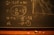 A blackboard with mathematical equations written in chalk, including variables like Q and P, and calculations involving these variables. An eraser and pieces of chalk are on the chalkboard's tray.