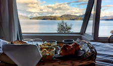 Cozy breakfast nook with fresh pastries, coffee, and a view of the sunrise.