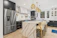 silver french door refrigerator beside white wooden table
