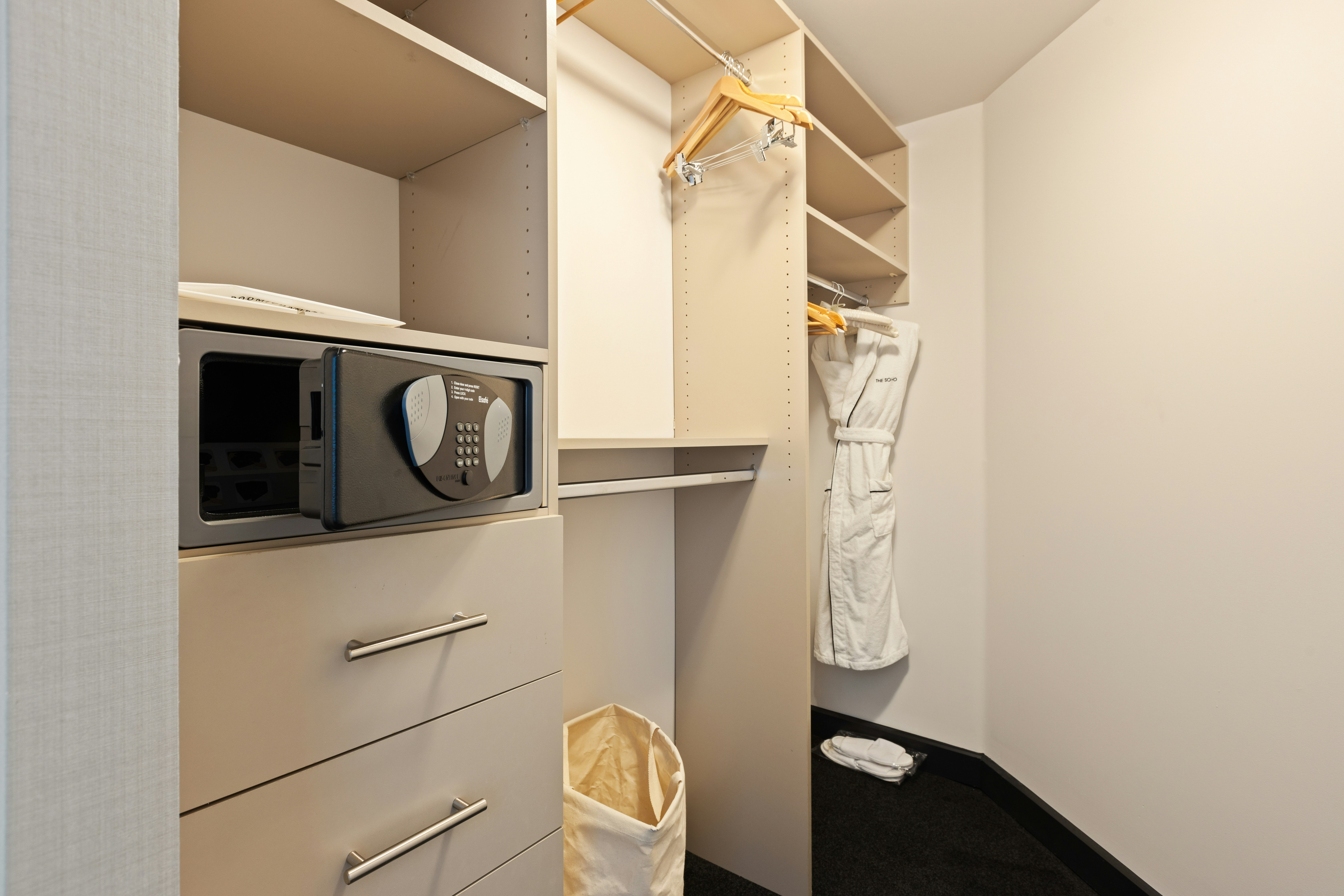 white pants hanging on white wooden cabinet