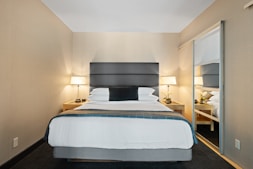 white bed linen on bed
