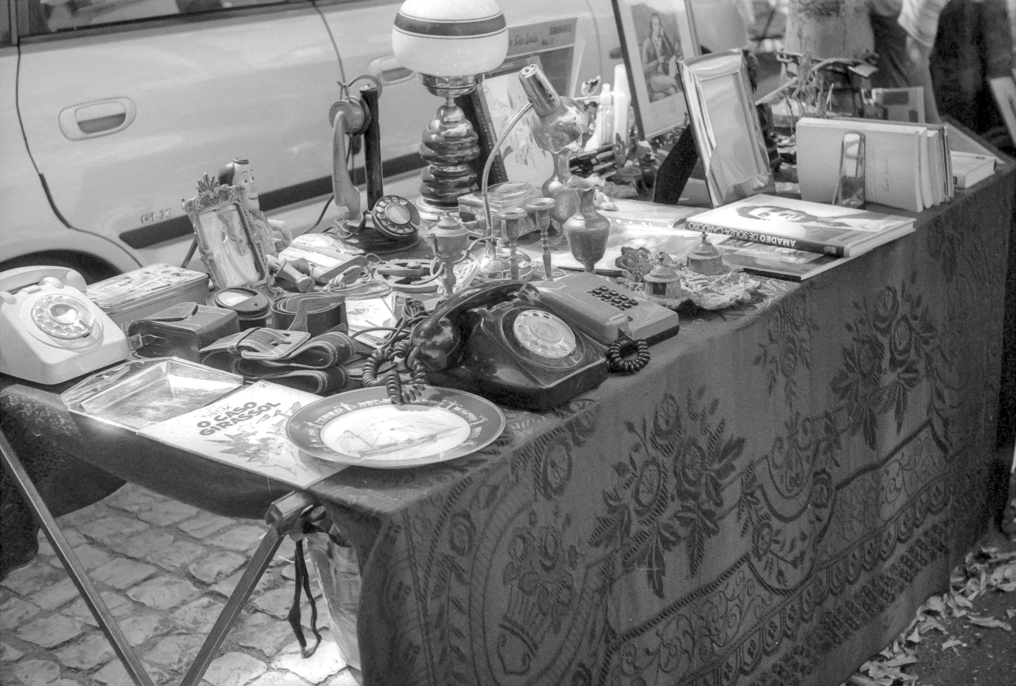 grayscale photo of table with plates and mugs