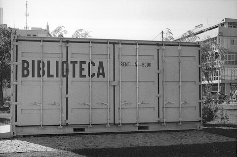 gray steel container van on gray asphalt road during daytime