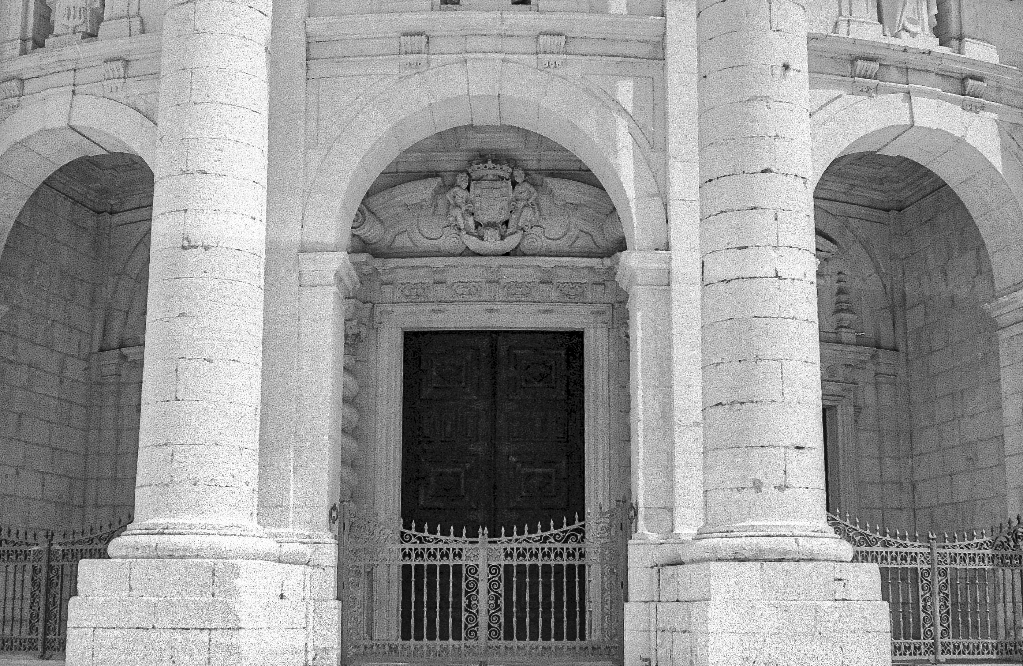 white concrete building with black metal gate