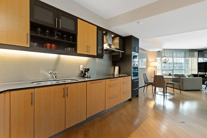 Wood cabinetry in an open kitchen that connects to the living area