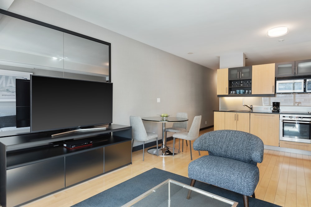 black flat screen tv on brown wooden tv rack