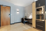 black and white table beside brown wooden door