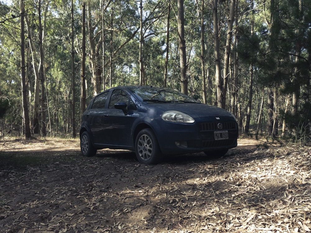 black bmw m 3 parked on forest during daytime