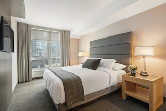 white bed linen on bed