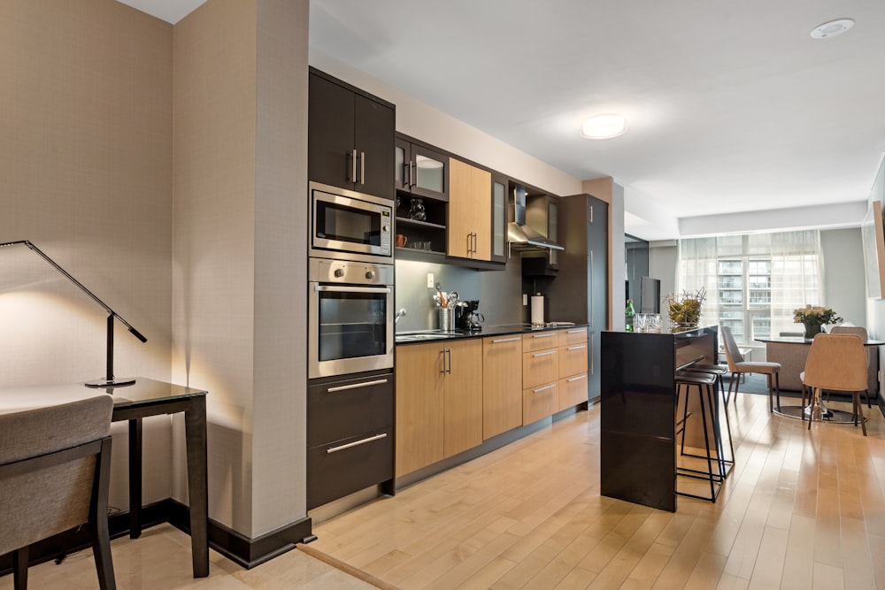 black and silver microwave oven on brown wooden kitchen cabinet