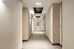 white and black hallway with lights turned on in the middle